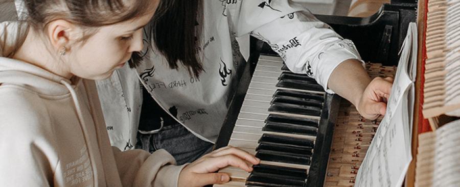 Teacher and student at a piano